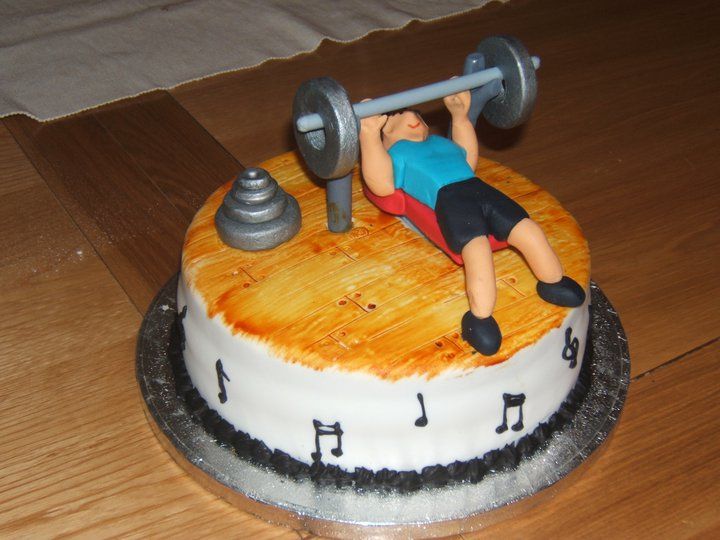 picture of cake with a bench press guy on top